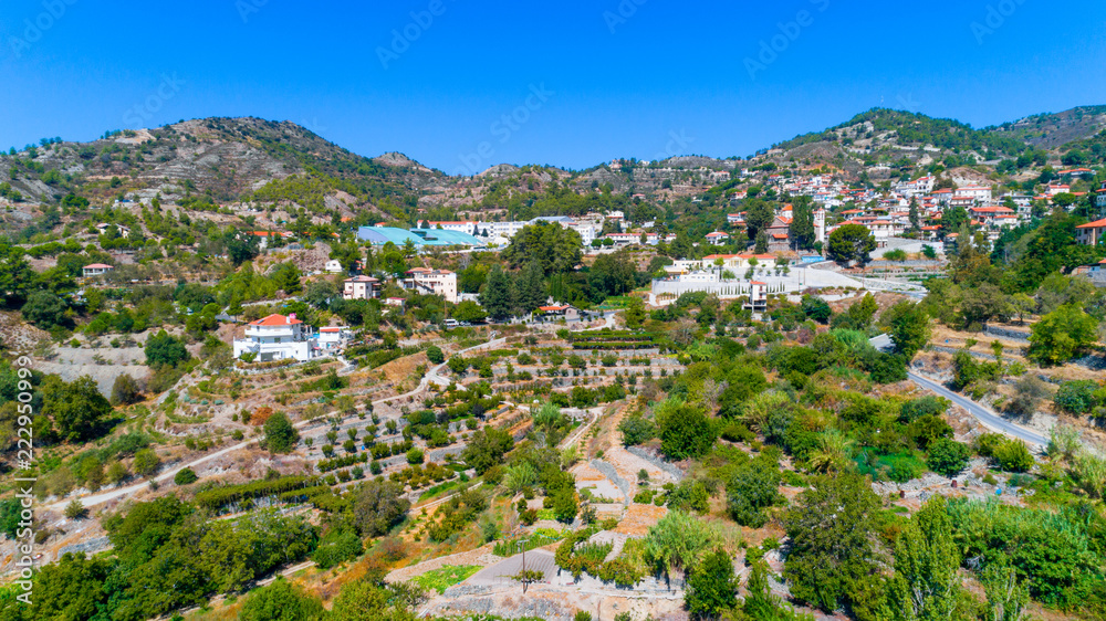 Aerial view of Agros village settlement on mountain Troodos, Limassol district, Cyprus. Bird's eye view of traditional houses with ceramic tile roof, church, countryside and rural landscape from above