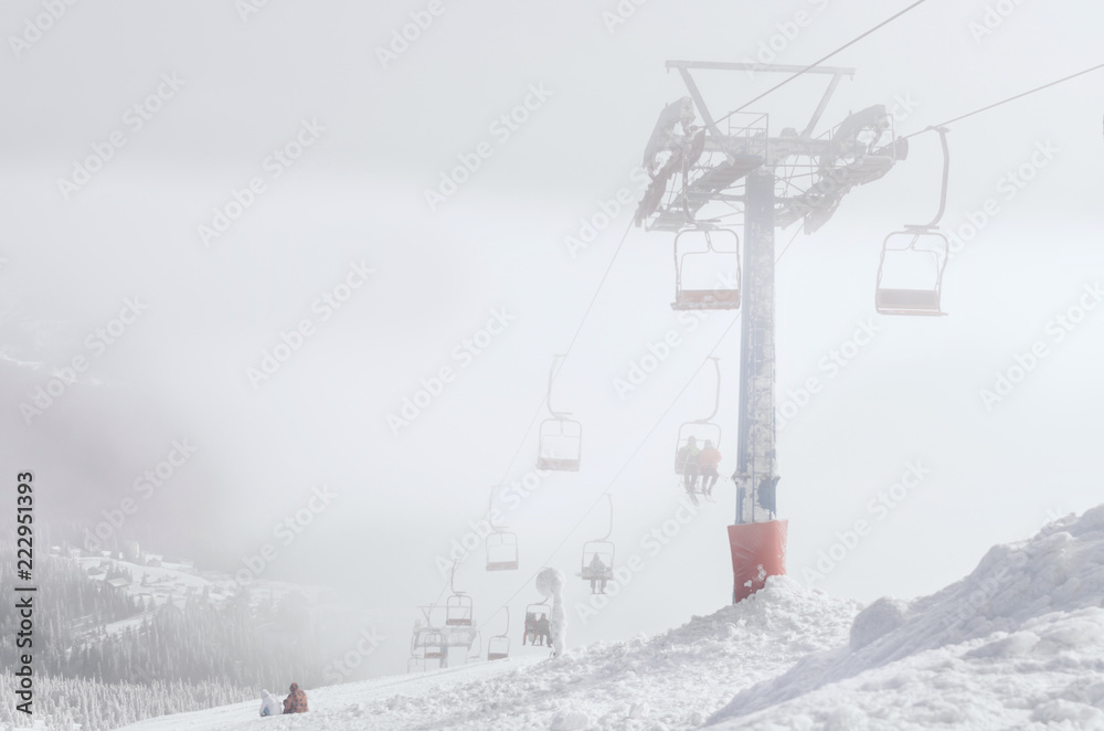Obraz premium Ski lift chairs on bright winter day