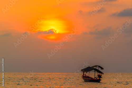 Traditionnal long tail boat at sunset