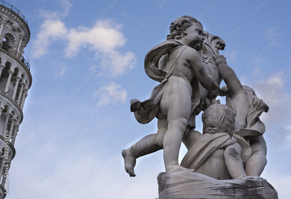 the beautiful fountain of the putti with the background of the tower of Pisa.