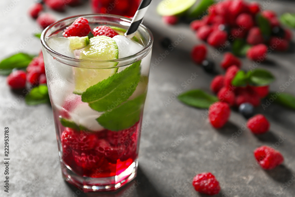 Glass of fresh raspberry mojito on table Glass of fresh raspberry mojito on table
