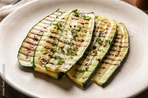 Tasty grilled zucchini on plate, closeup