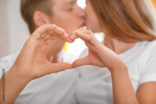 Young couple holding hands ...