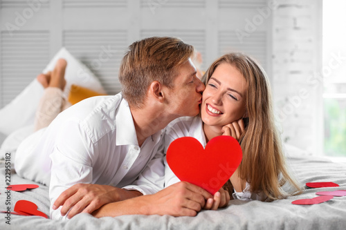 Happy young couple with red...
