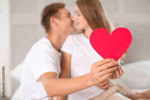 Happy young couple with red...