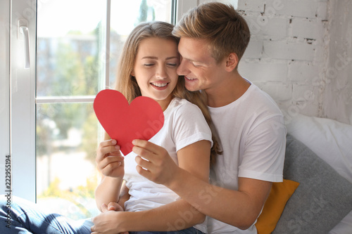 Happy young couple with red...