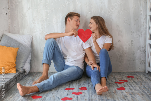 Happy young couple with red...