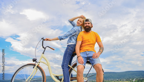 Date ideas. Man and woman rent bike to discover city. Couple in love date outdoors cycling. Bike rental or bike hire for short periods of time. Couple with bicycle romantic date sky background