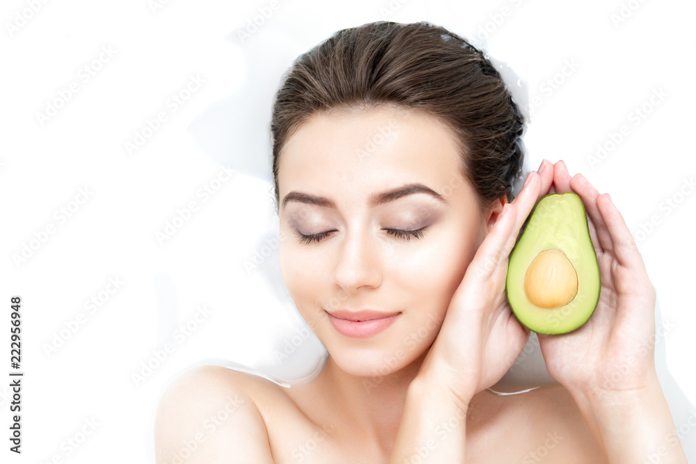 Portrait of young sexy female woman adult with clean pure skin taking spa smiling relaxing in bath with avocado white soap shampoo water. Skin beauty health care concept. Body part bare shoulder