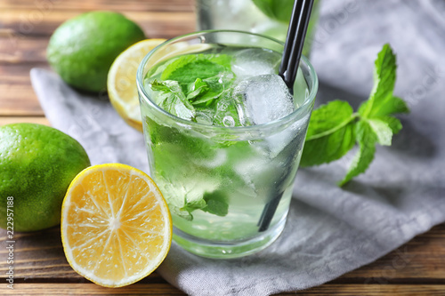 Glass of fresh mojito on wooden table