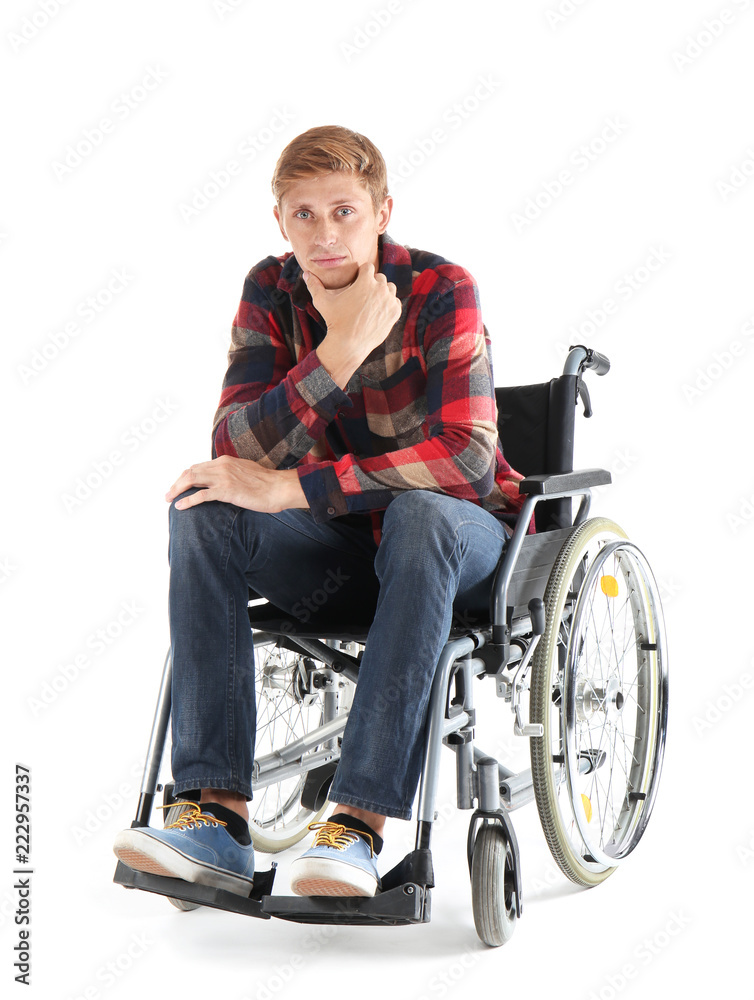 Thoughtful young man sitting in wheelchair on white background Thoughtful young man sitting in wheelchair on white background