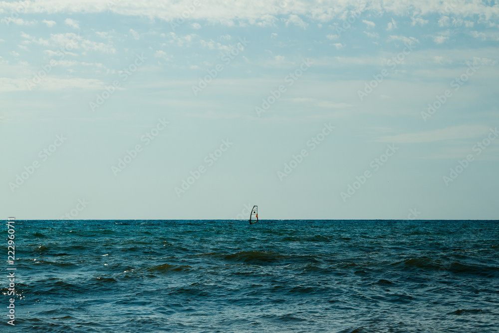 sail in the water against the horizon sail in the water against the horizon