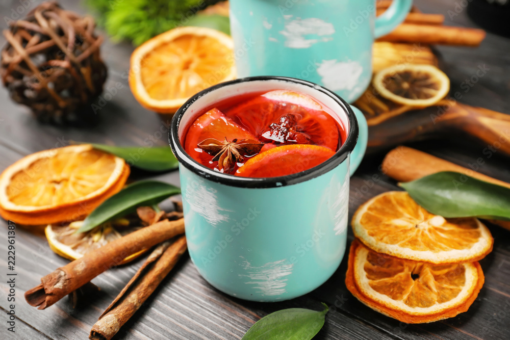 Metal cup of delicious mulled wine on wooden table Metal cup of delicious mulled wine on wooden table