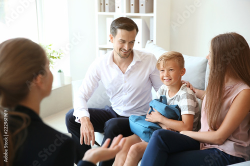 Bild auf Leinwand Young couple and their son meeting with headmistress at school