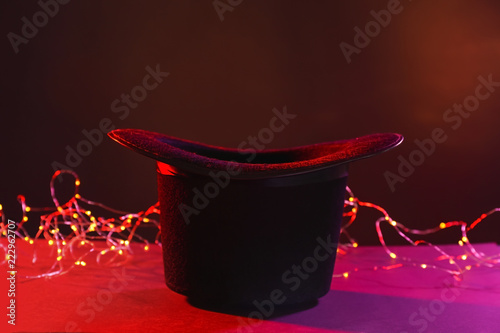 Vászonkép Black magician hat on dark color background