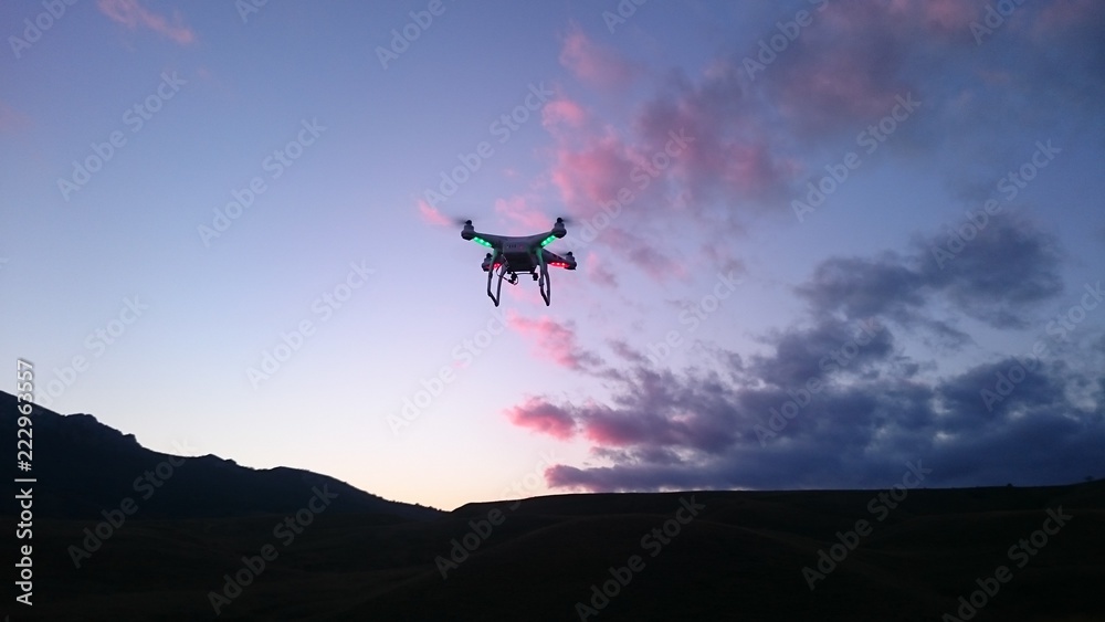 drone against the background of the evening sky with clouds and mountains drone against the background of the evening sky with clouds and mountains