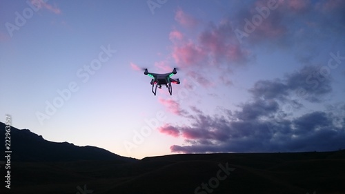 drone against the background of the evening sky with clouds and mountains