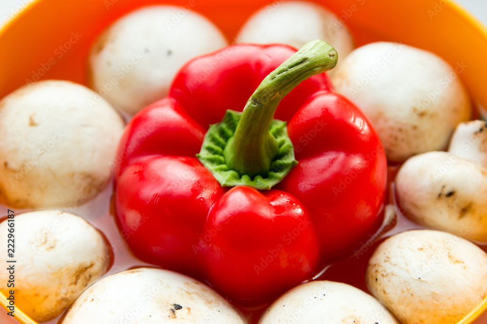 champignons around the pepper in water in a bowl champignons around the pepper in water in a bowl