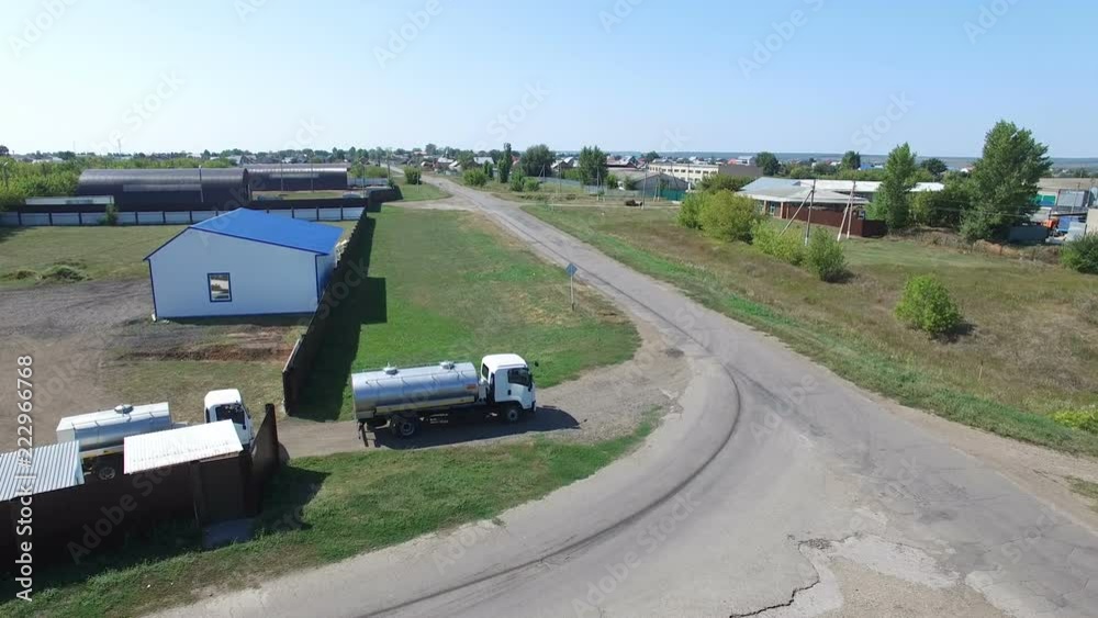 Drone view of trucks riding out of manufacture yard Drone view of trucks riding out of manufacture yard