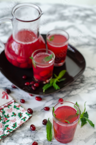 Fresh cranberry drink on marble background.