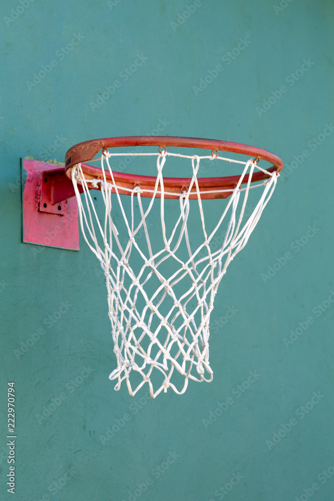 basketball ring on a stone turquoise wall close-up