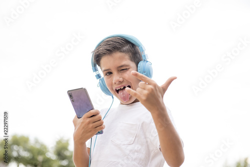 Happy boy listening to his smartphone