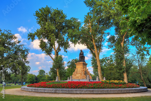 Canvas Print Statue of Joost van den Vondel with tulips in the Vondelpark in Amsterdam, the N