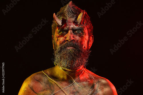 Halloween devil with bloody horns on head photo