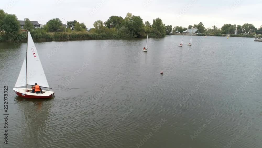 Small boats run by young people. Competition. Yachts sail to the sea. Regatta. Races of sailing sports courts.
Small boats run by young people. Competition. Yachts sail to the sea. Regatta. Races of sailing sports courts.