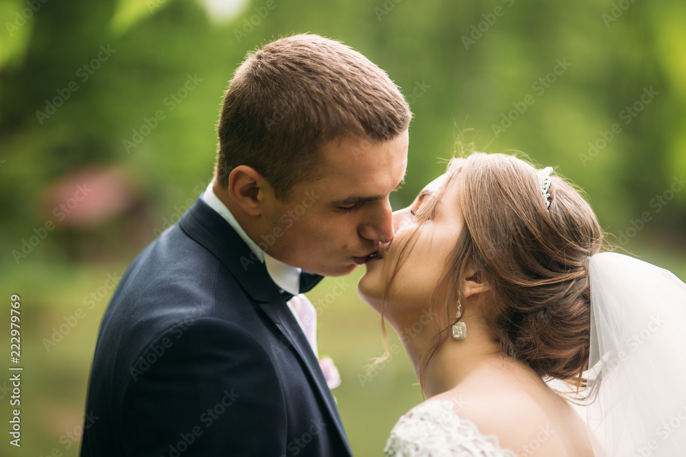 Groom and bride kiss each other in their wedding day Groom and bride kiss each other in their wedding day