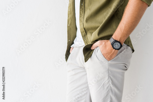 cropped view of casual man with hands in pockets