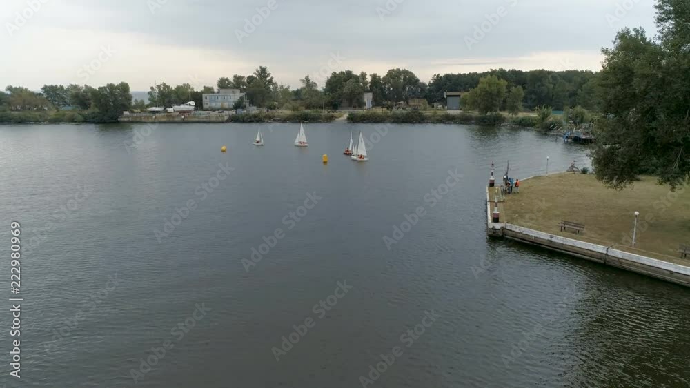 Small boats run by young people. Competition. Yachts sail to the sea. Regatta. Races of sailing sports courts.
Small boats run by young people. Competition. Yachts sail to the sea. Regatta. Races of sailing sports courts.