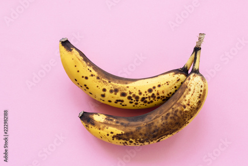 Overripe bananas on pink background, horizontal, top view