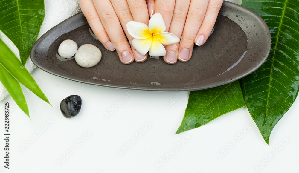 Spa manicure top view with flowers, green leaves, towel Spa manicure top view with flowers, green leaves, towel
