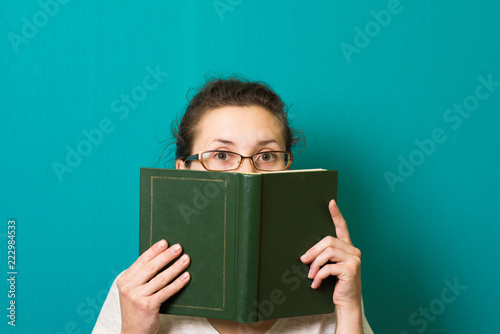 beautiful brunette girl in glasses with book