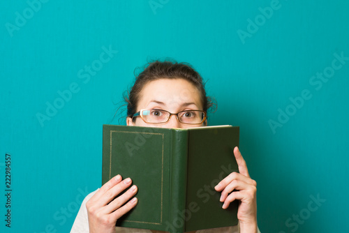 beautiful brunette girl in glasses with book