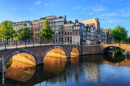 Beautiful view of the iconic UNESCO world heritage Keizersgracht canal  in Amsterdam, the Netherlands, on a sunny summer morning with sunshine, a blue sky and reflection