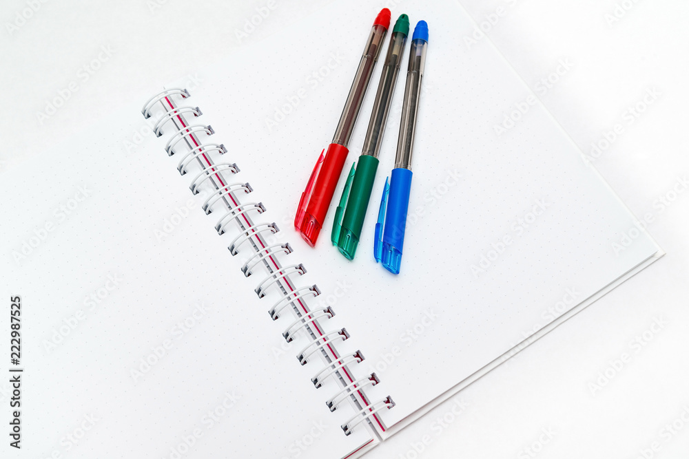 Blank note pad for notes, white background with pens Blank note pad for notes, white background with pens