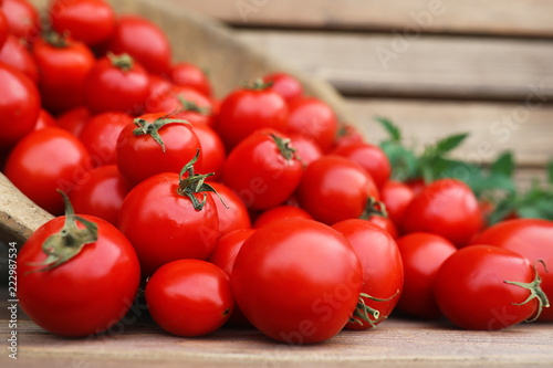 Fresh tomato crop in a wooden bowl