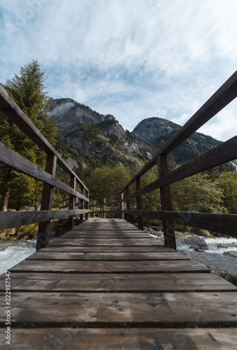 wood bridge in mountain in val di mello - sondrio italy