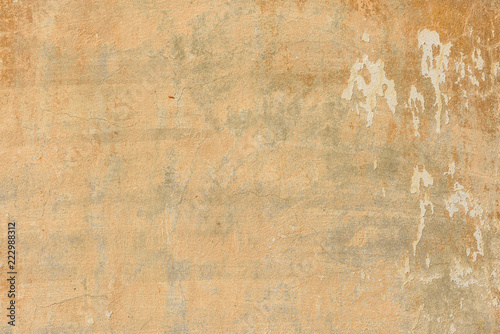 texture of old peeling yellow plaster
