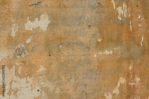 texture of old peeling yellow plaster