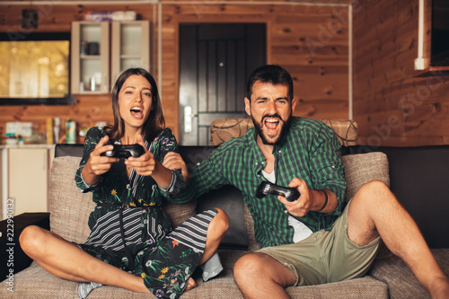 Young Couple Playing Video Game Together at Home
