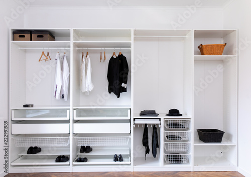 Obraz na płótnie clothes hanging on rail in white wardrobe
w salonie