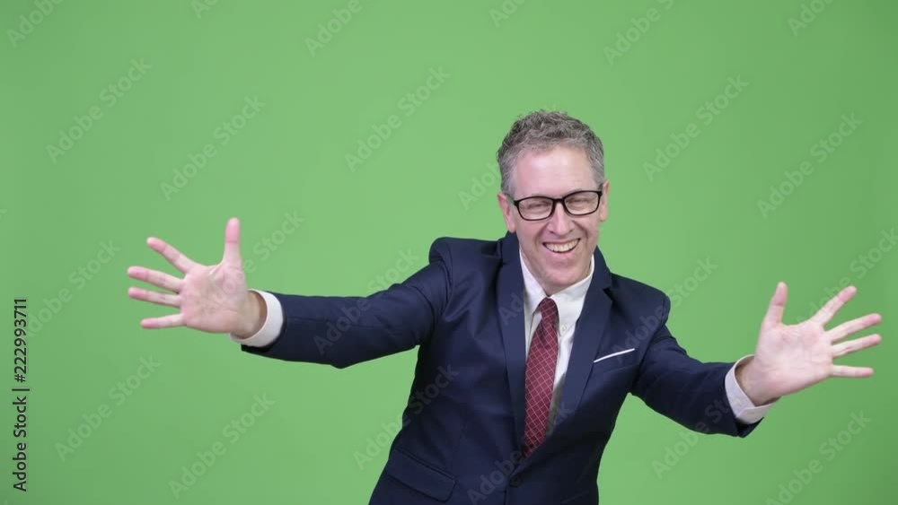 Studio shot of happy mature businessman with surprise gesture Studio shot of happy mature businessman with surprise gesture