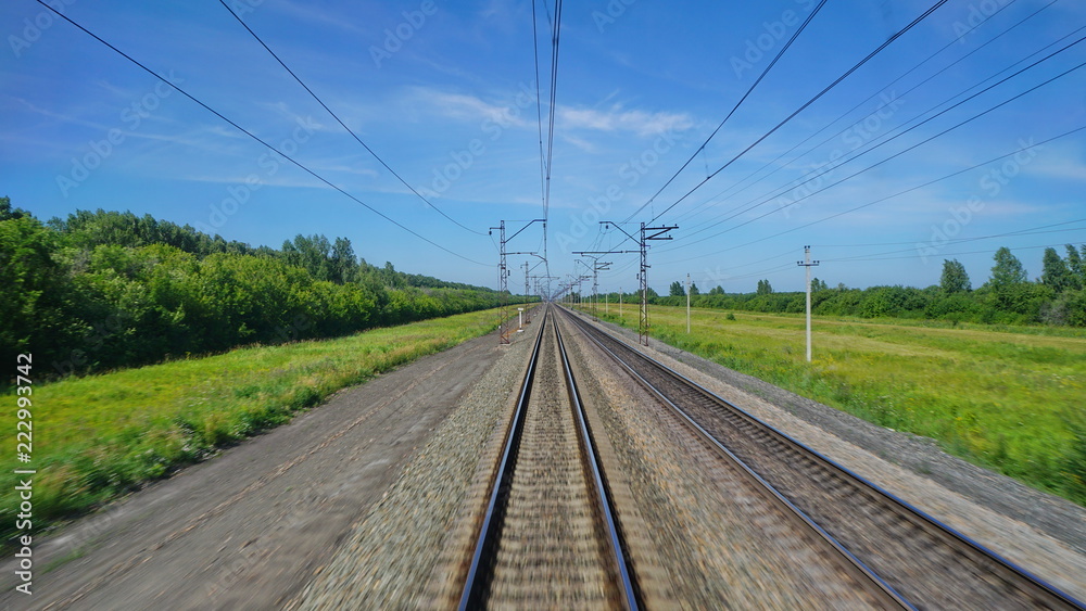 view of the railway from the window of an electric train that rides on rails