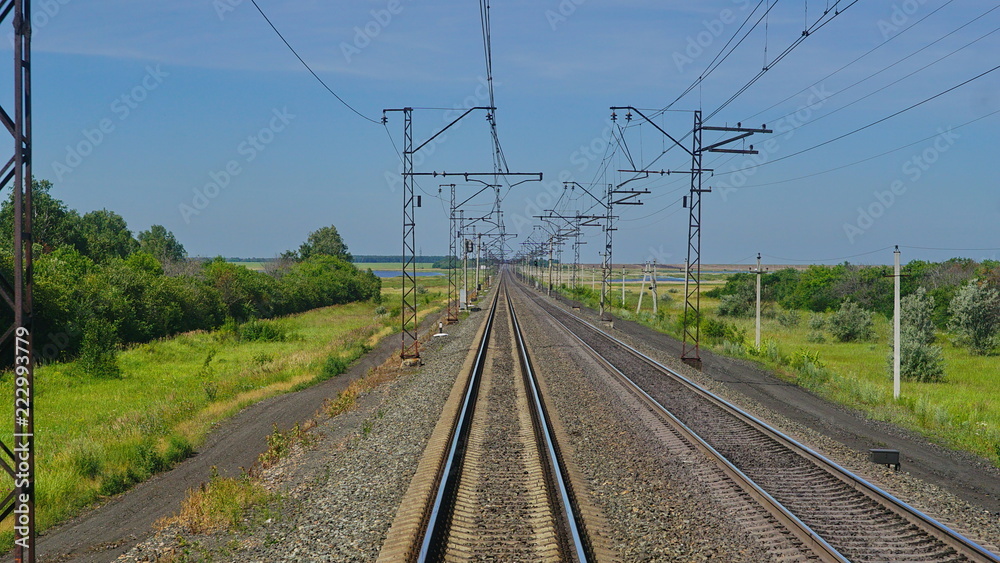view of the railway from the window of an electric train that rides on rails