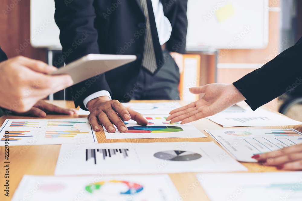 close up hand of marketing manager employee pointing at business document during discussion at meeting room , Notebook on wood table - Business concept close up hand of marketing manager employee pointing at business document during discussion at meeting room , Notebook on wood table - Business concept