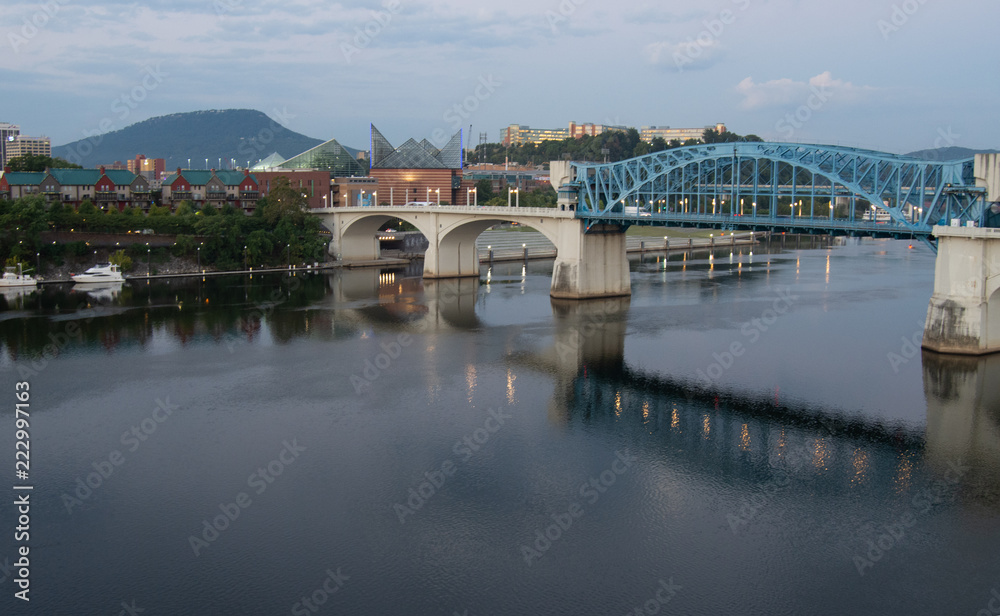 Blue bridge across a river at sunrise, leading to downtown Chattanooga, Tennessee