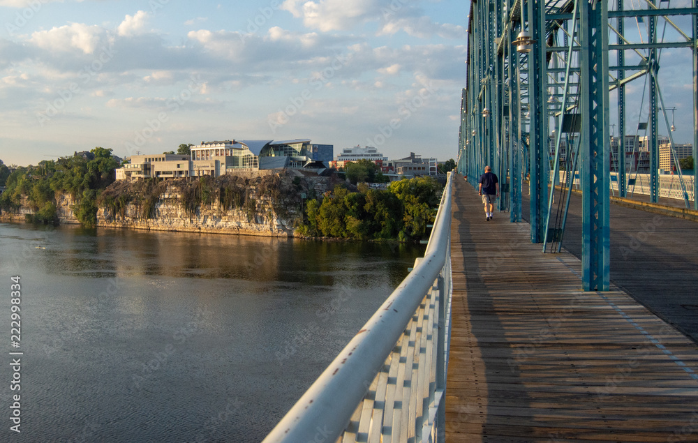 Man walking on bridge toward landmark in Chattanooga, Tennessee,